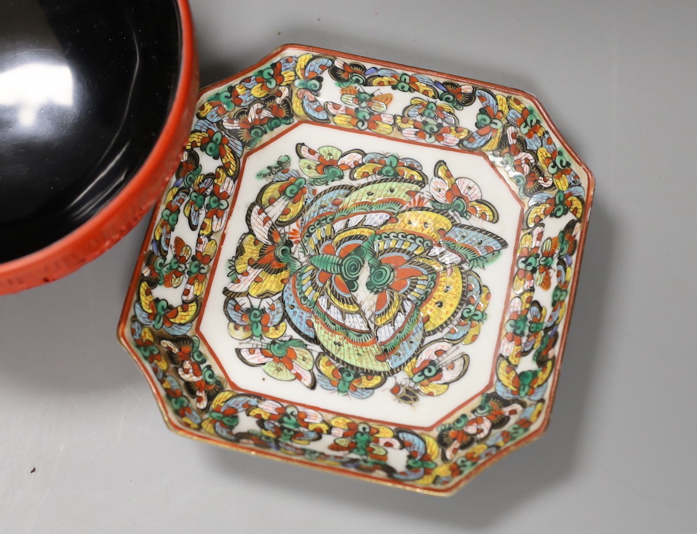 A Chinese cinnabar lacquer bowl, a similar box and cover and two Chinese famille verte thousand butterfly dishes